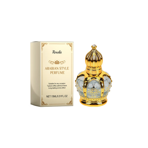 Ornate gold Roxelis Arabian style perfume oil bottle beside its cream and gold box